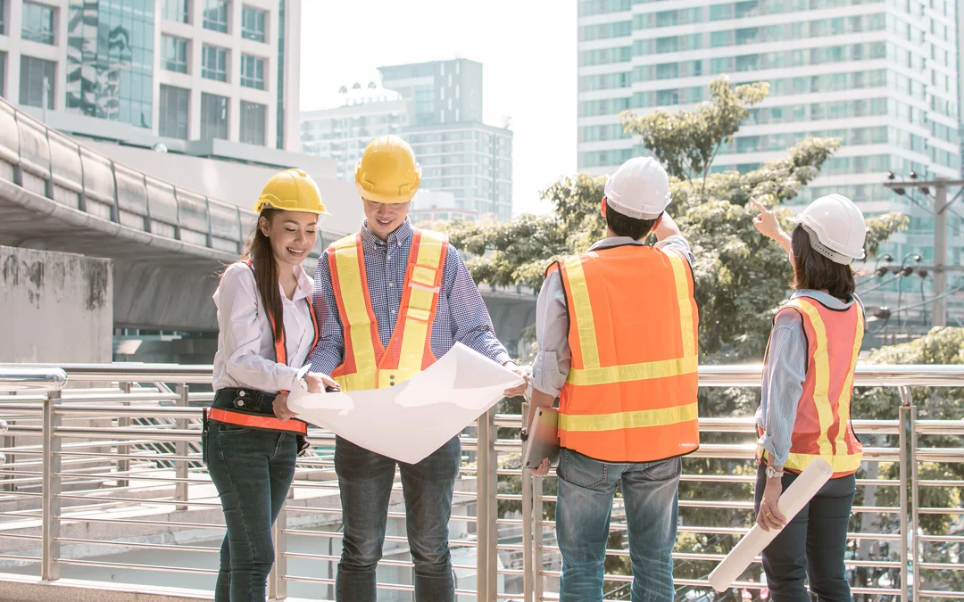 Four people at construction site with equipment