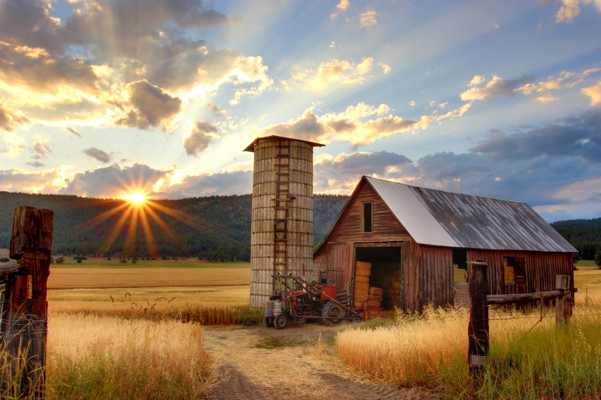 A small red barn in the sunset
