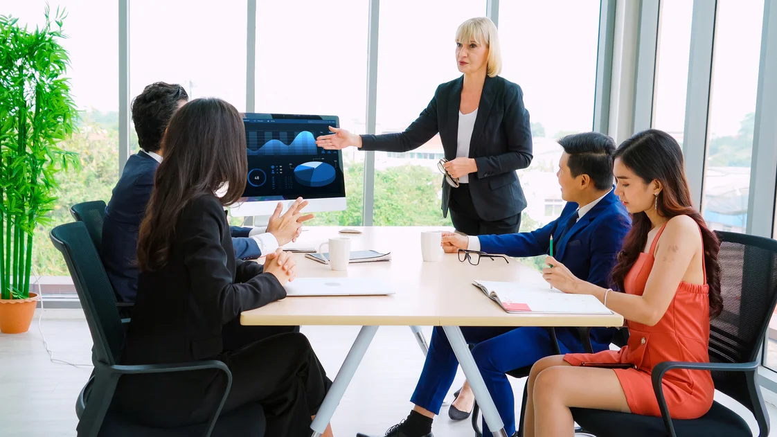 A woman presenting the results of data analysis in a meeting room