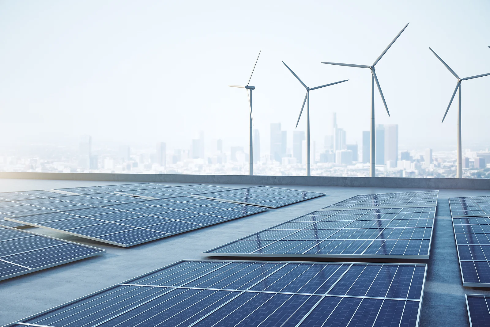 solar panels and wind turbines with a cityscape behind